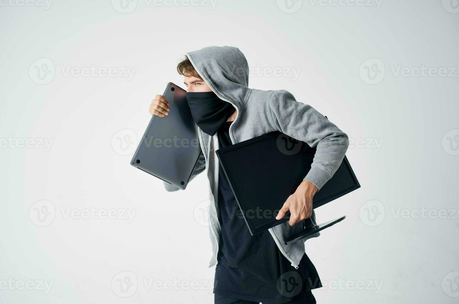 male thief crime anonymity caution balaclava light background photo