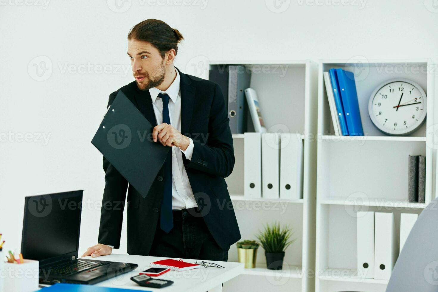 man in a suit in the office with documents lifestyle photo
