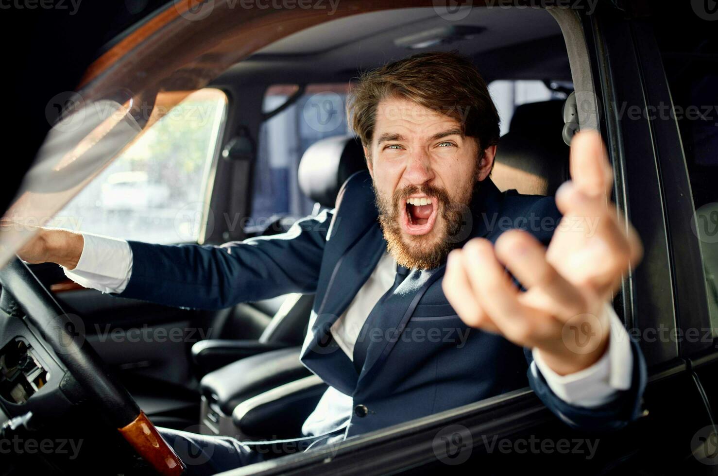 bearded man in a suit in a car a trip to work service photo