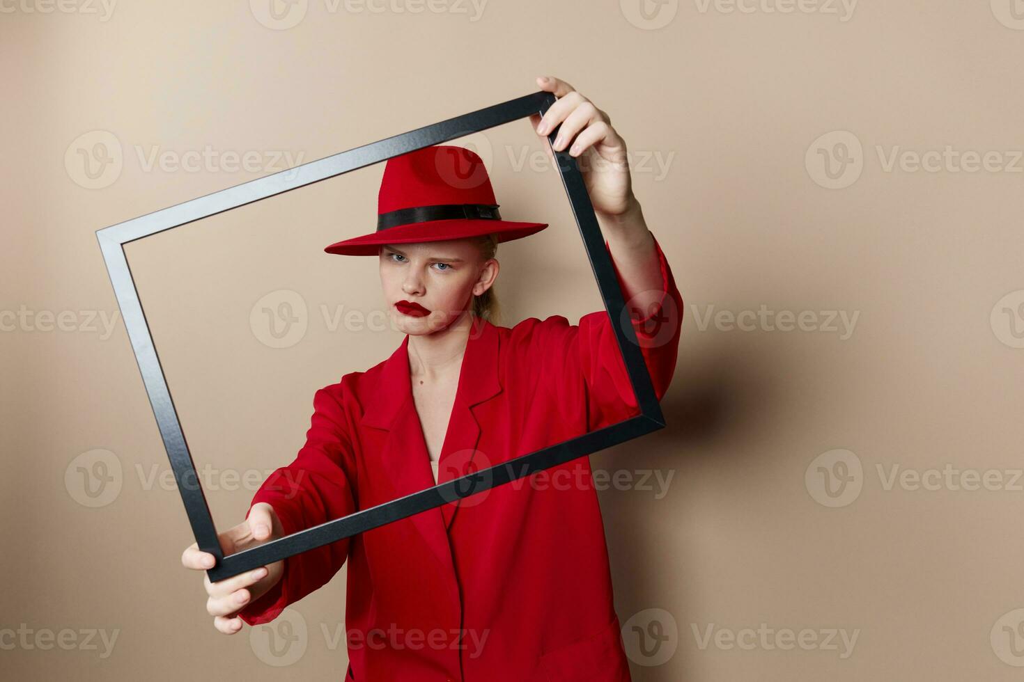 portrait of a woman frame in hand in red hat and jacket Lifestyle posing photo