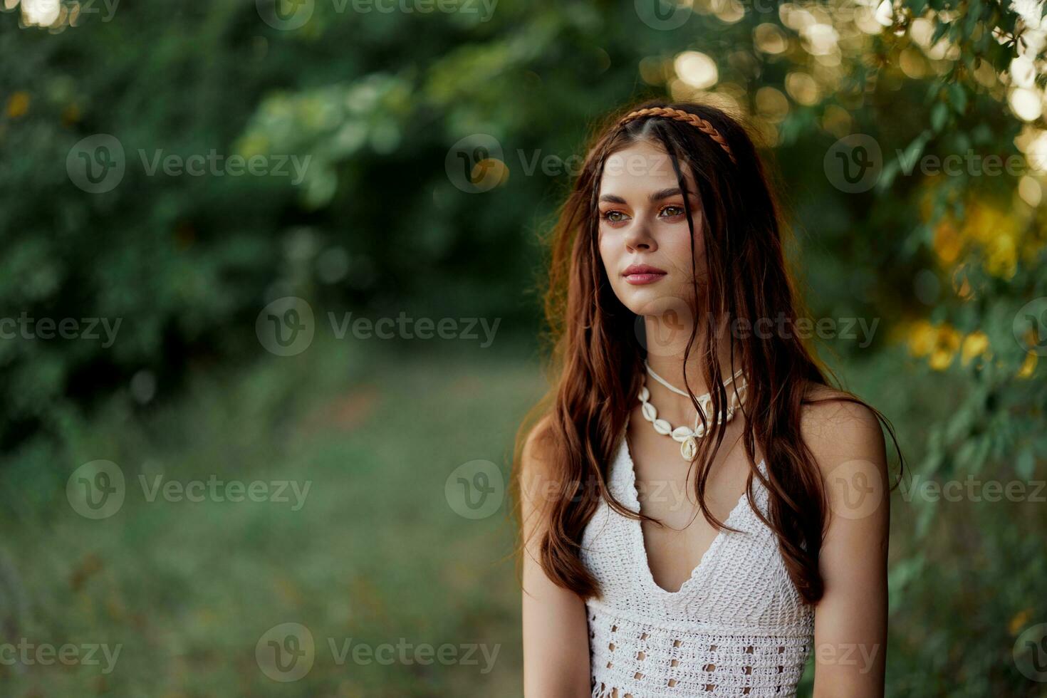 A woman dressed as a hippie with pigtails on her head travels outdoors at a campground in the fall and enjoys life photo