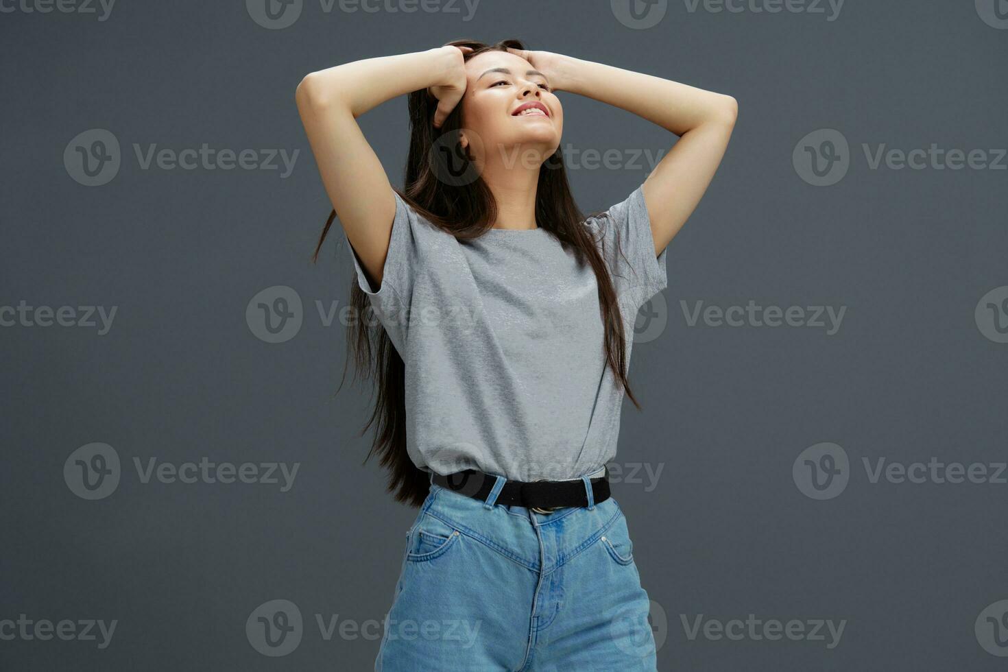 pretty woman in a t-shirt and jeans posing Youth style isolated background photo