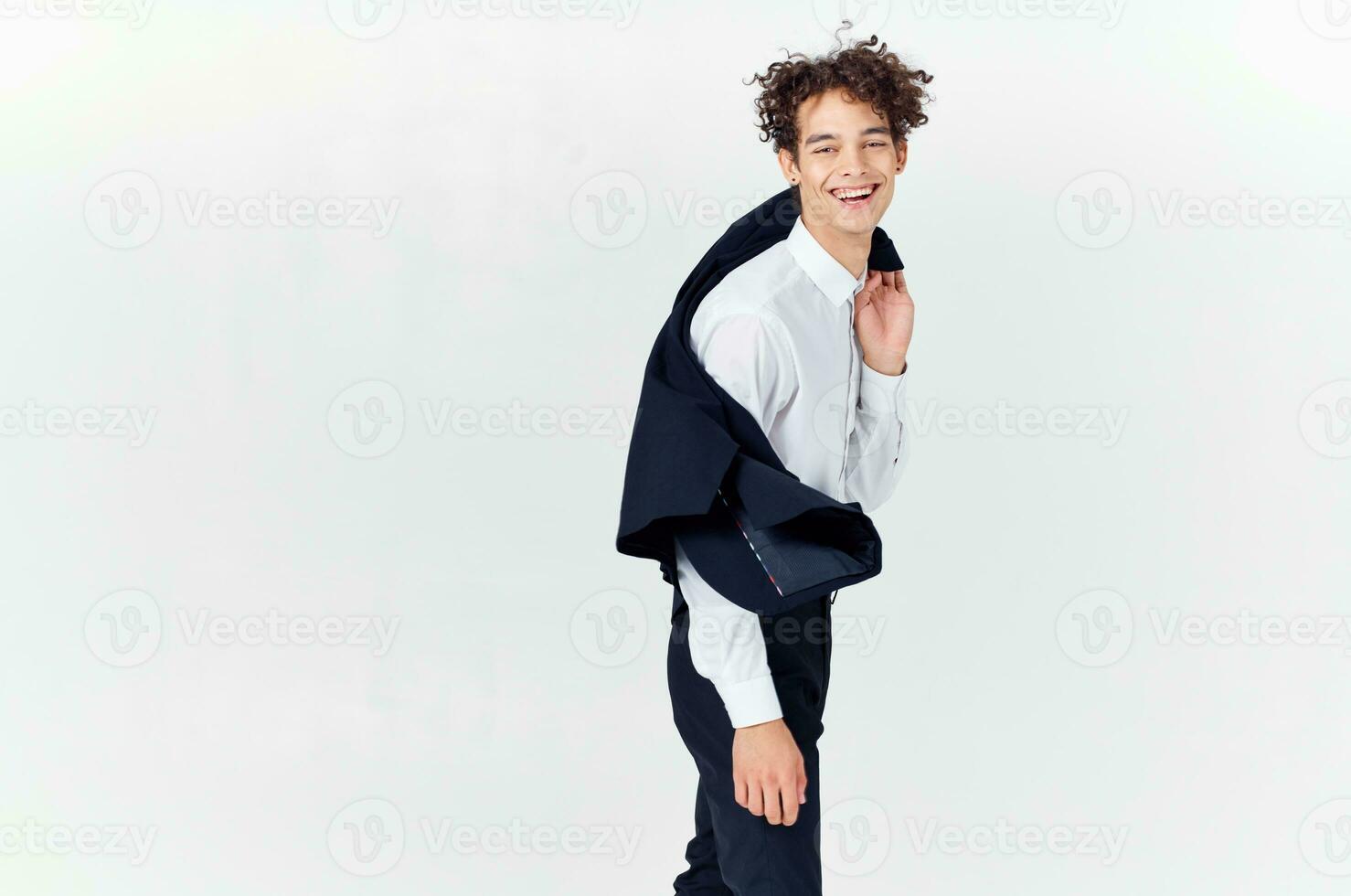 Cheerful man with curly hair in a business suit fashion modern style photo