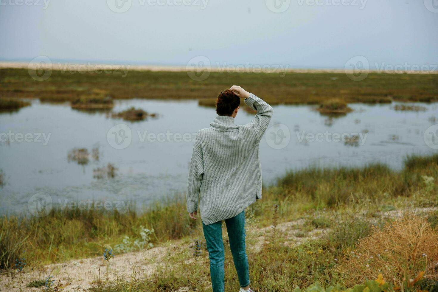 woman admire nature walk behind photo