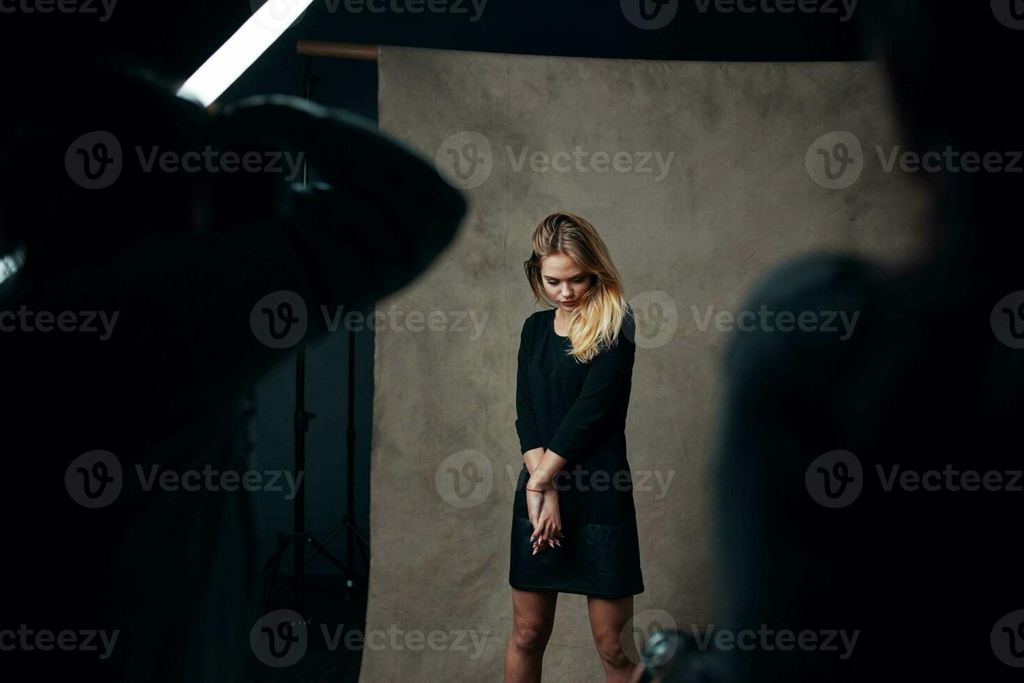 blonde girl in studio posing for photographer fashion lifestyle photo