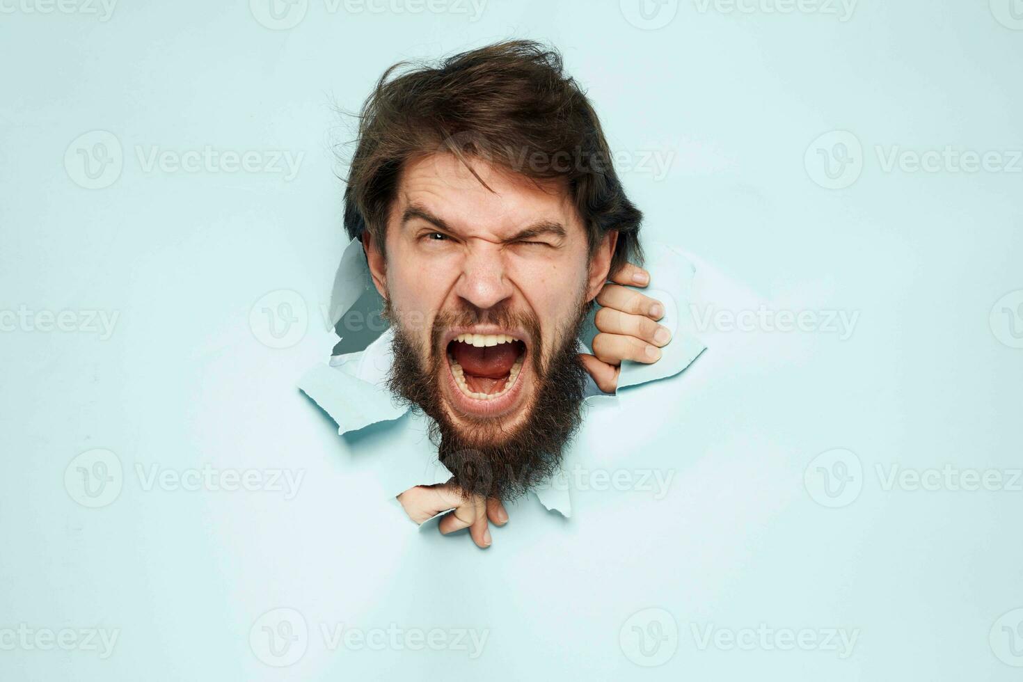 screaming bearded man peeking out from behind the wall emotions work photo