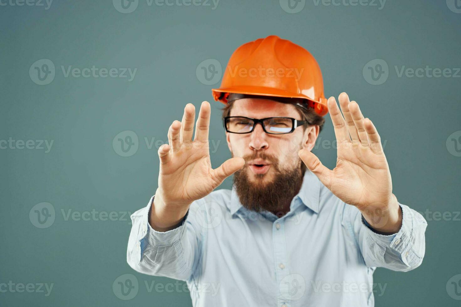 emotional man wearing glasses orange helmet work industry photo