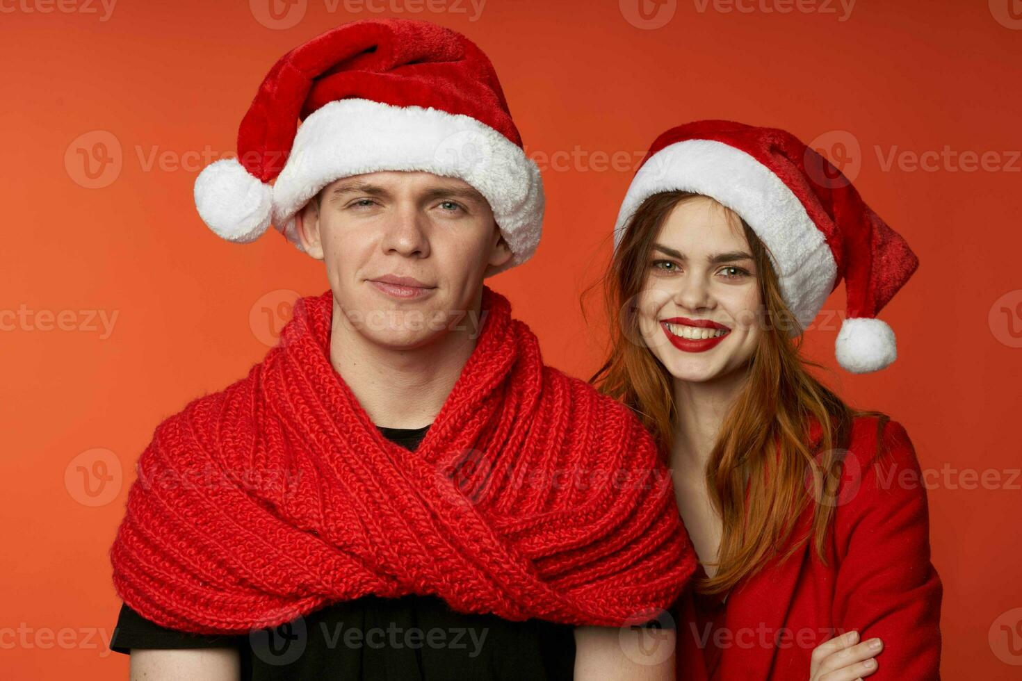 family in santa hats fun new year holiday red background photo