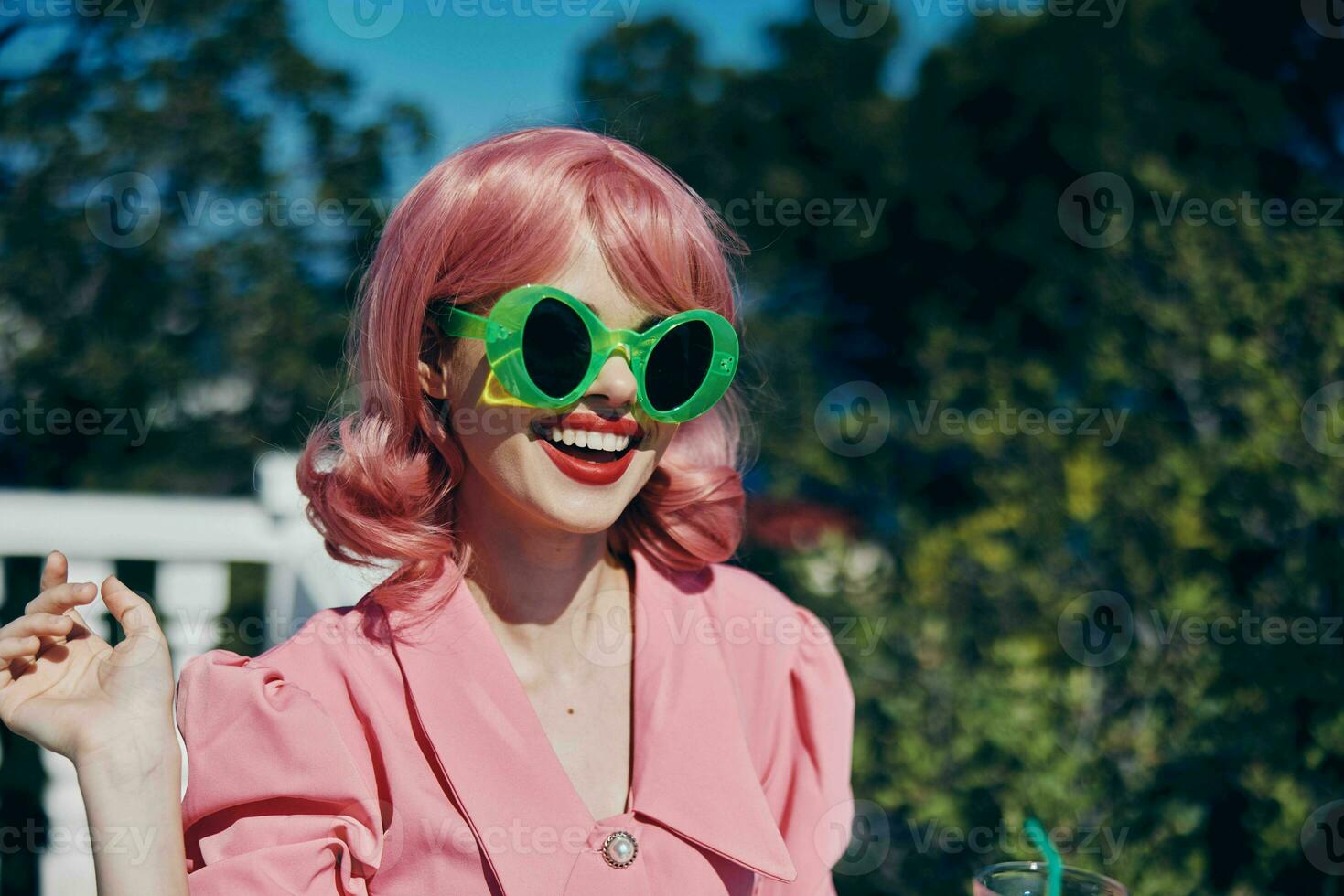 fashionable woman enjoying a colorful cocktail hotel terrace Happy female relaxing photo