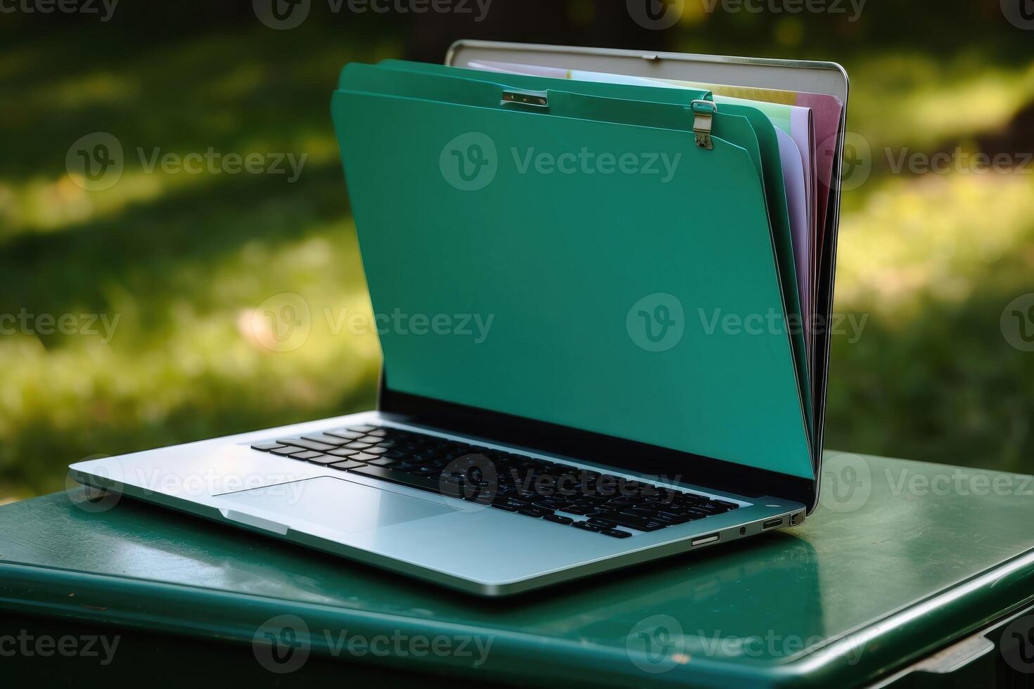 File folder on laptop screen with a green background created with technology. photo