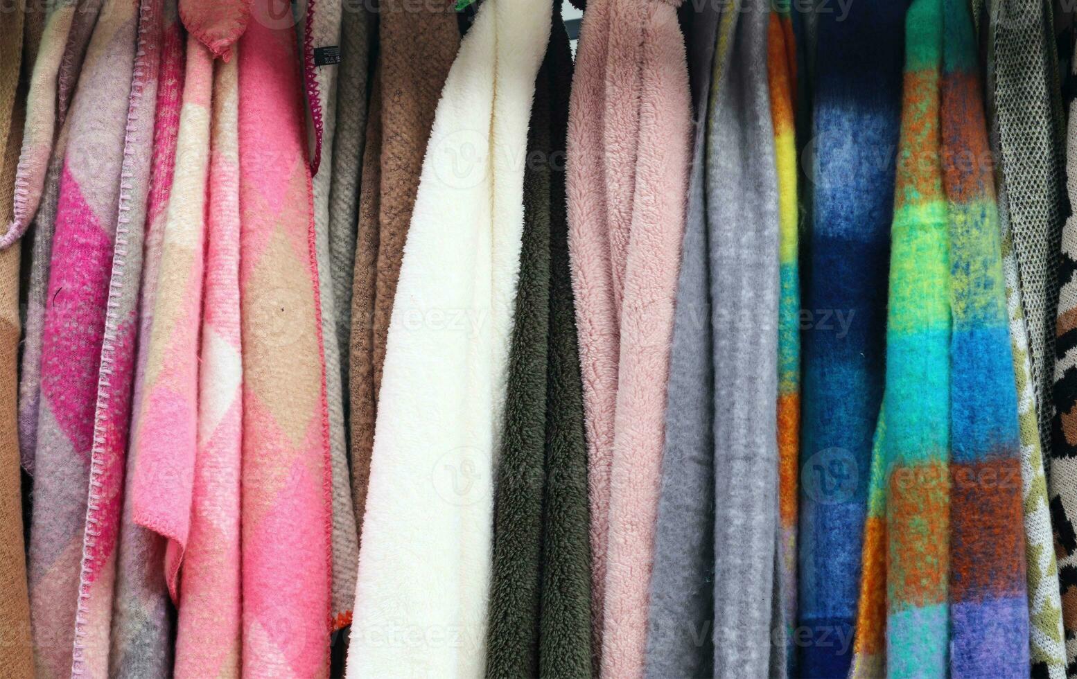 Detailed close up view on samples of cloth and fabrics in different colors found at a fabrics market photo