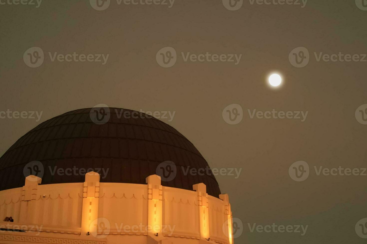 Griffith Observatory with a full moon in the background photo