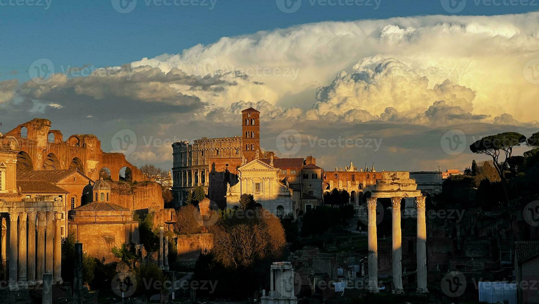 Ancient Rome at sunset, with a huge cloud in the sky photo