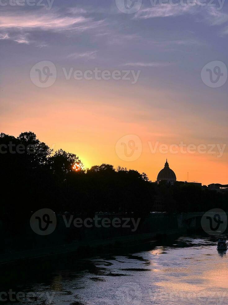 Sunset over the Tiber in Rome, with a view of the Cupolone photo