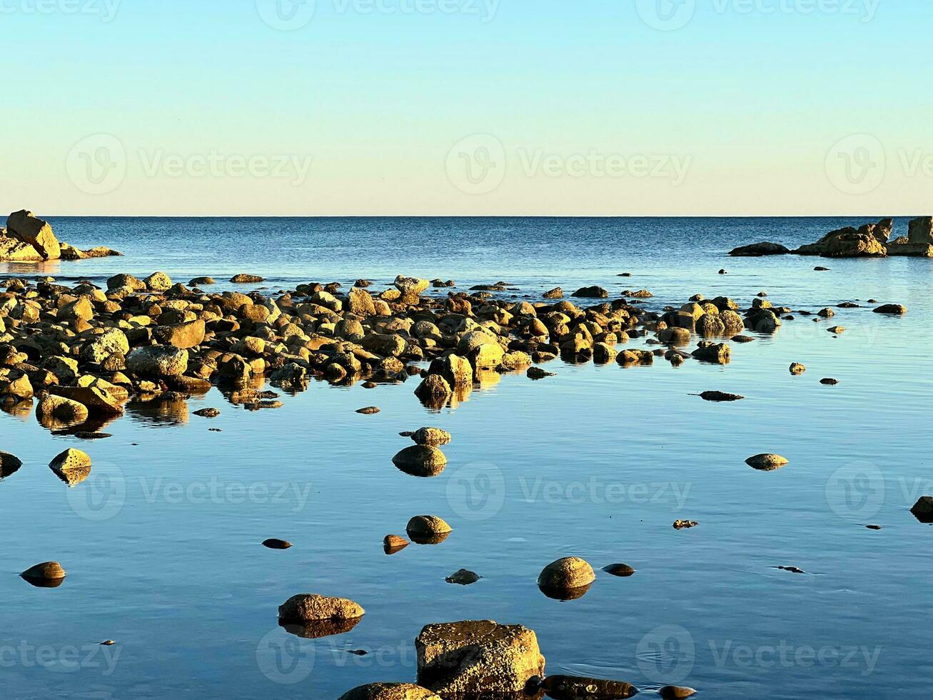 Rocks in the middle of the calm sea photo