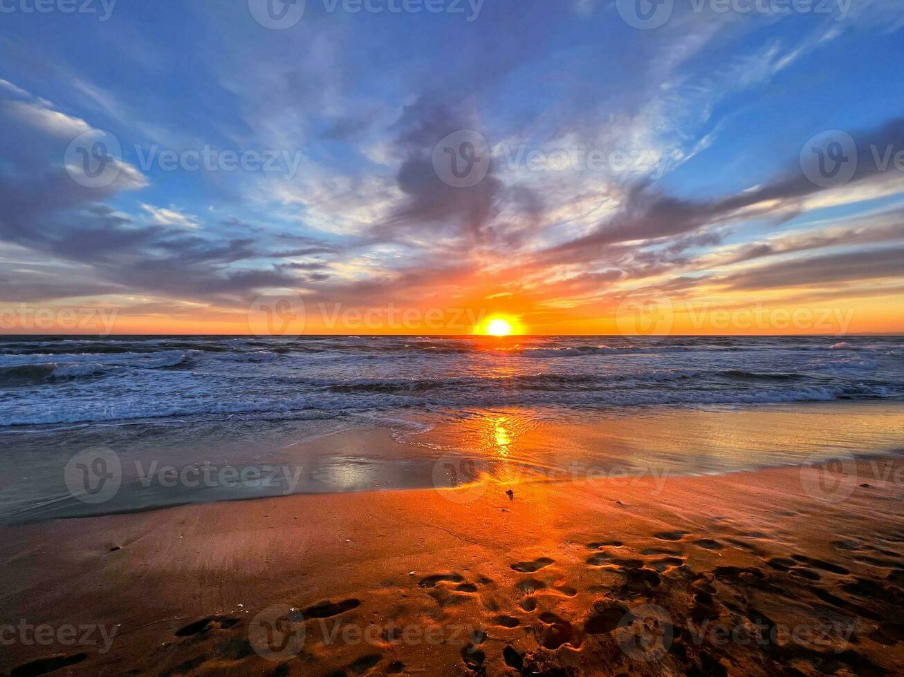 Sunset in the sea with cloudy sky photo