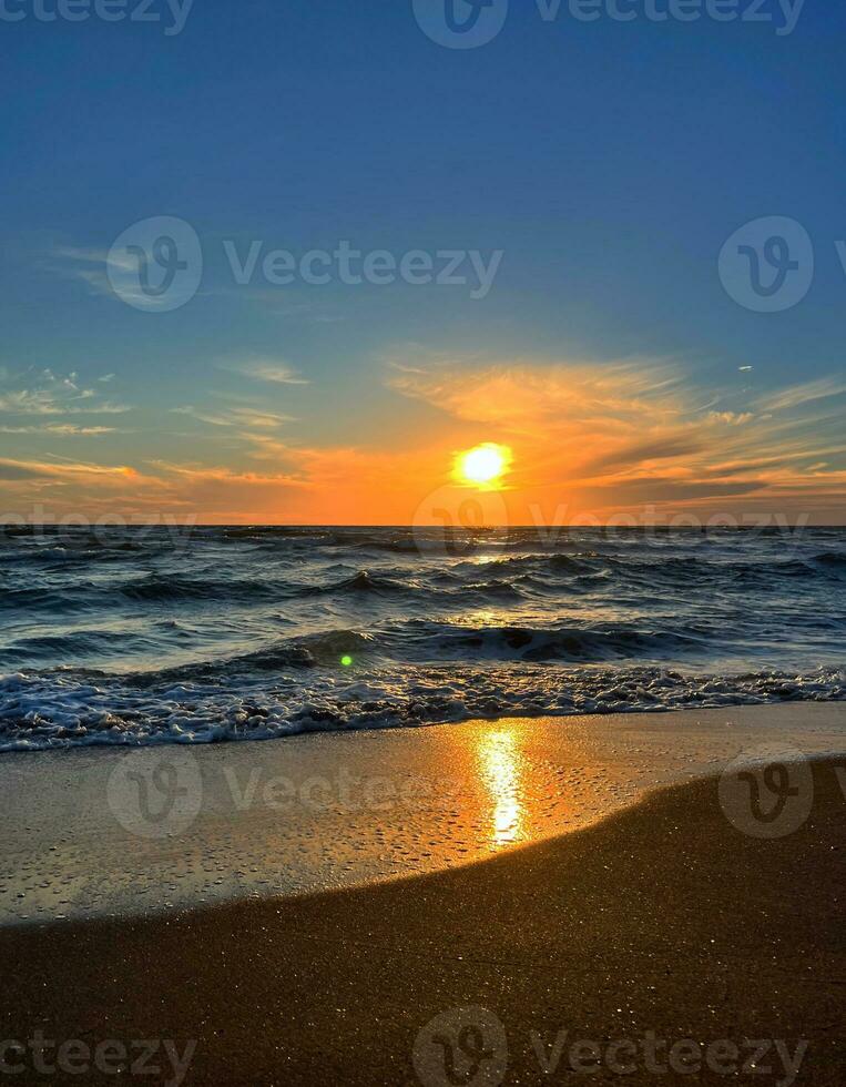 Sunset over the sea with cloudy sky photo