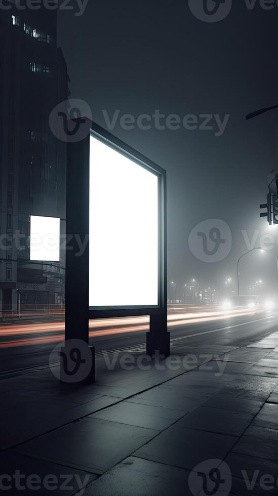 A large billboard on a city street at night. photo