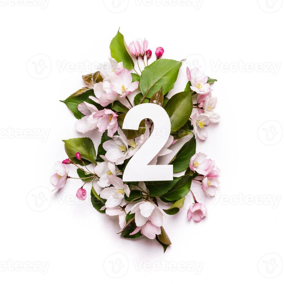Paper number two on background of apple trees. Minimal creative Layout with natural elements for your design photo