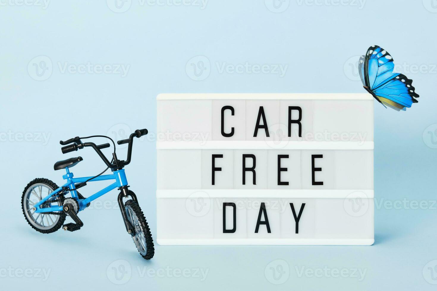 Car free day concept. Light box with Car free day text bicycle and butterfly. World bicycle day photo
