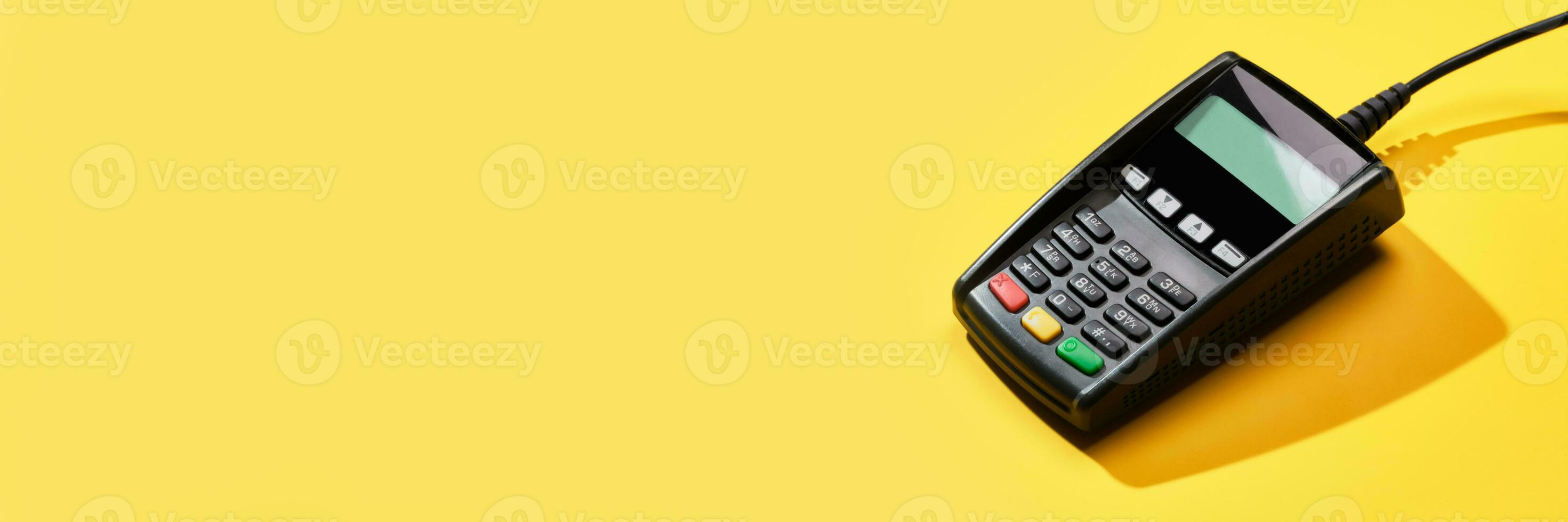 POS payment terminal on yellow background. Minimal financial service concept. Trendy shadows, copy space photo