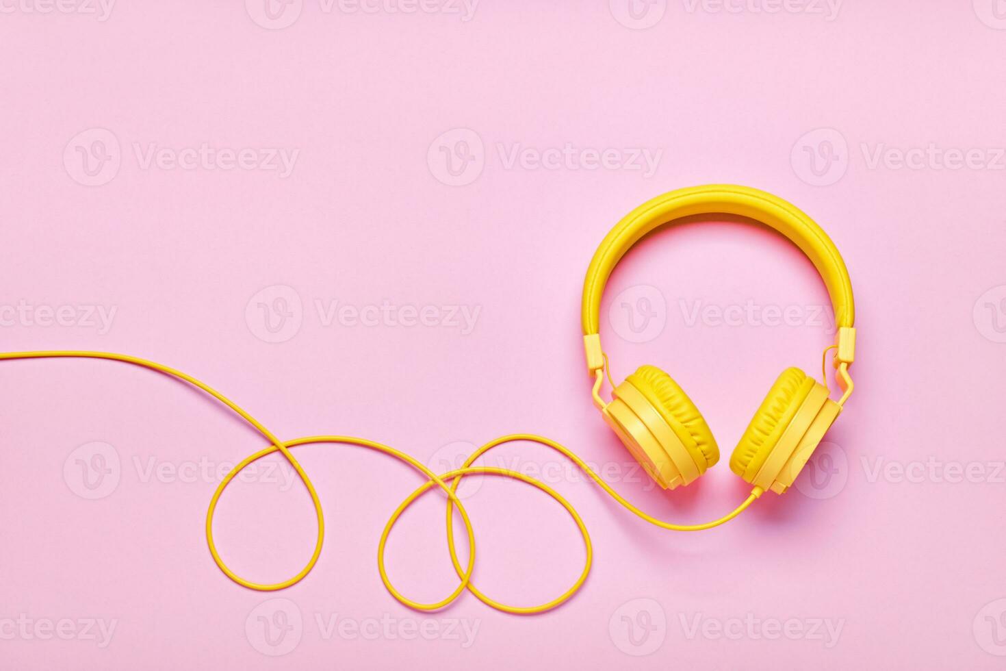 Yellow headphones on pink background. Minimal Music concept, flat lay, copy space photo