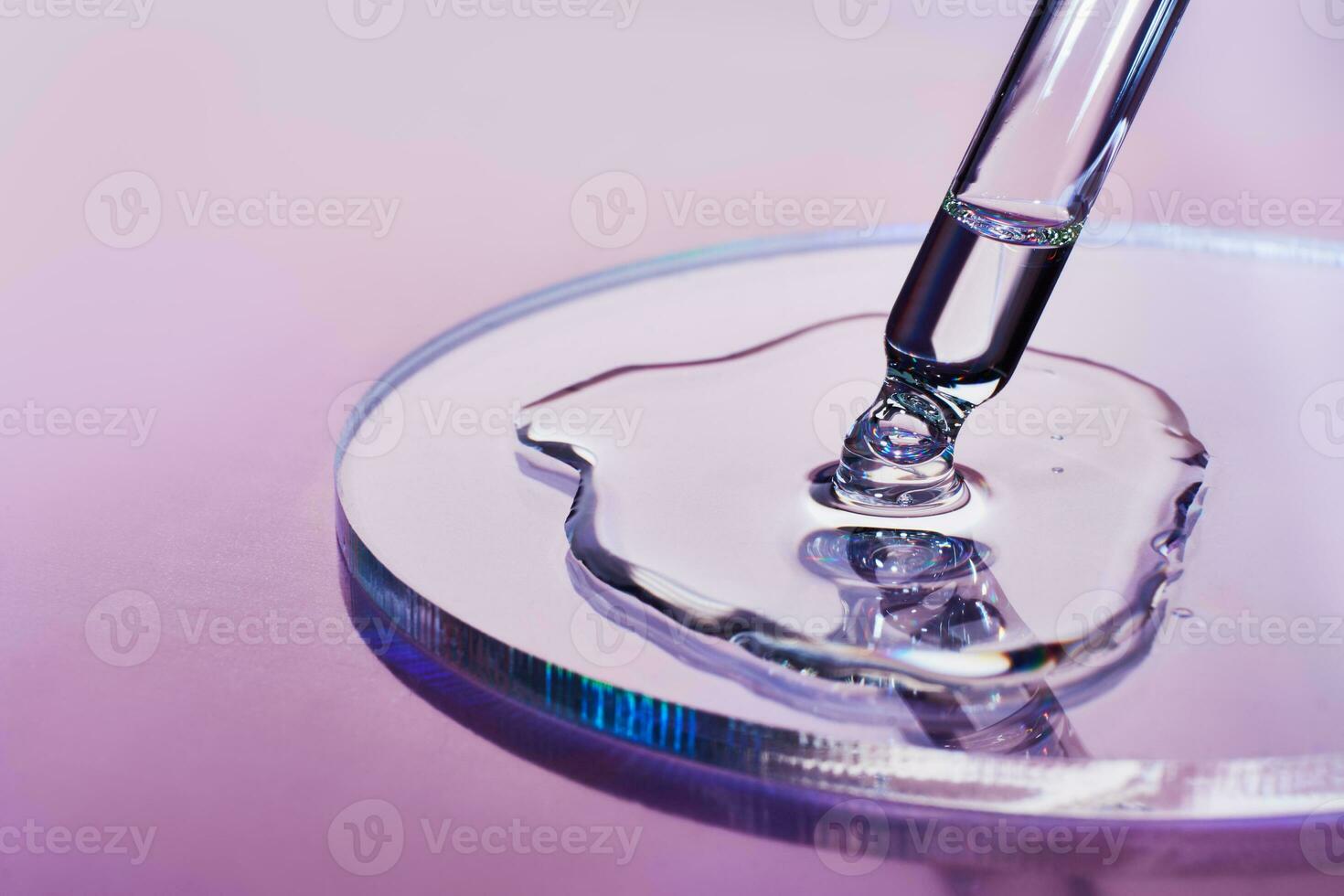 Pipette with sample of cosmetic product in petri dish on holographic background, iridescent highlights, selective focus photo