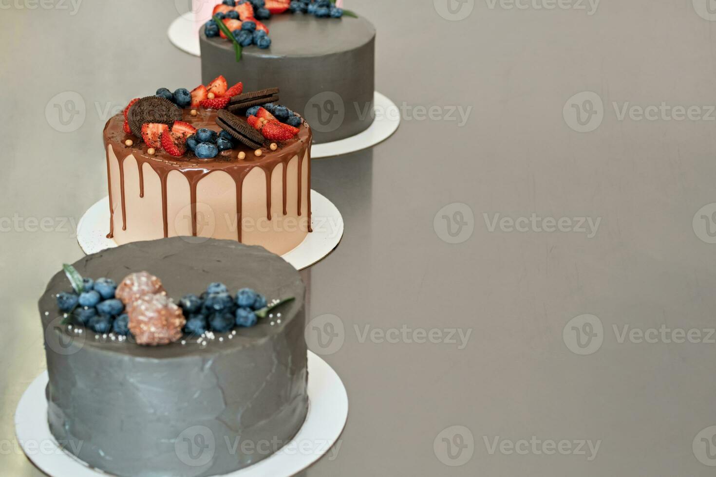 Festively decorated cakes on table. Confectionery for holiday. Selective focus photo