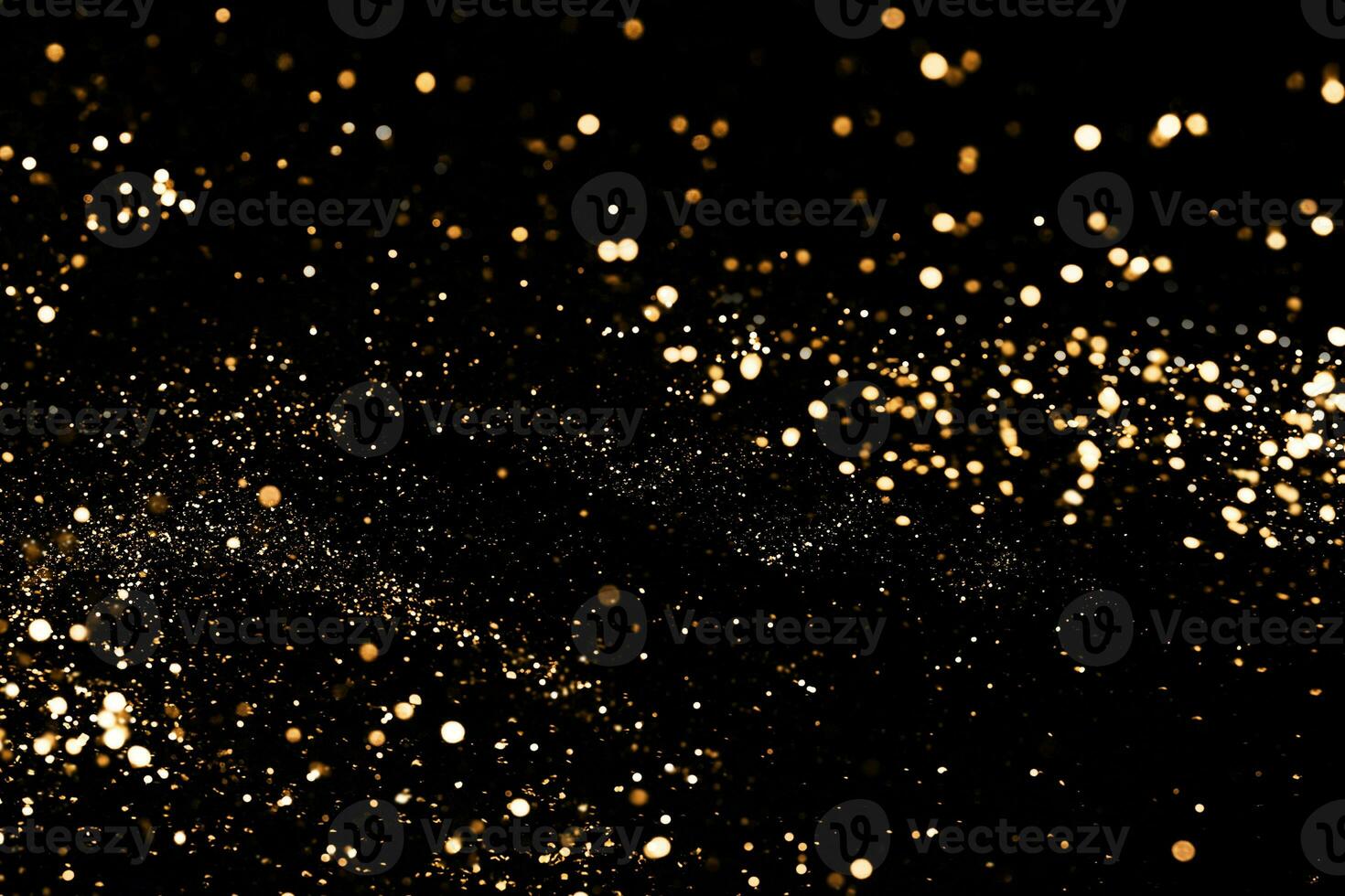 Black festive background. Abstract scattering of gold sparkles on black. Holiday backdrop, selective focus photo