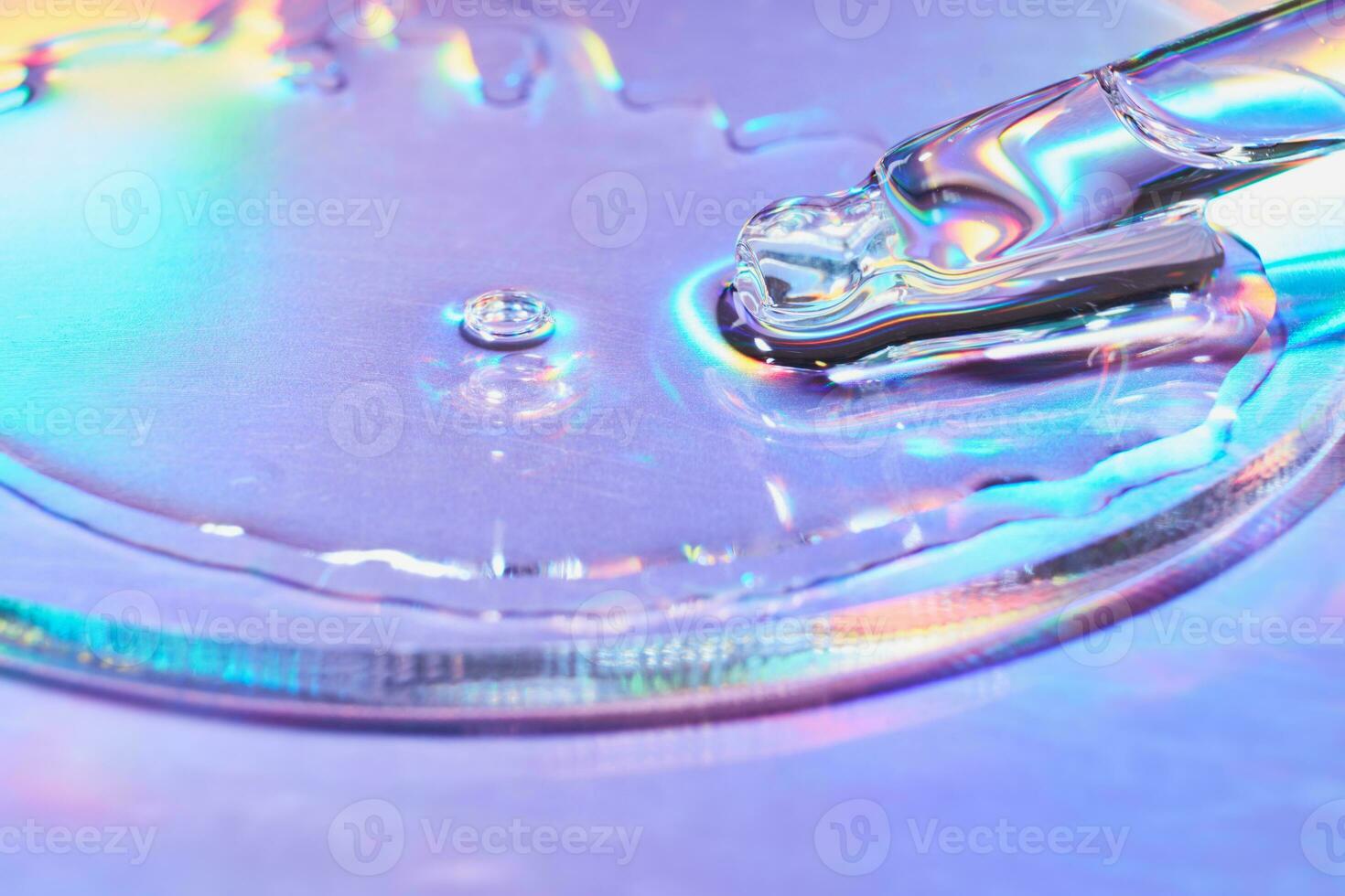 Pipette with sample of cosmetic product in petri dish on holographic background, iridescent highlights, selective focus photo