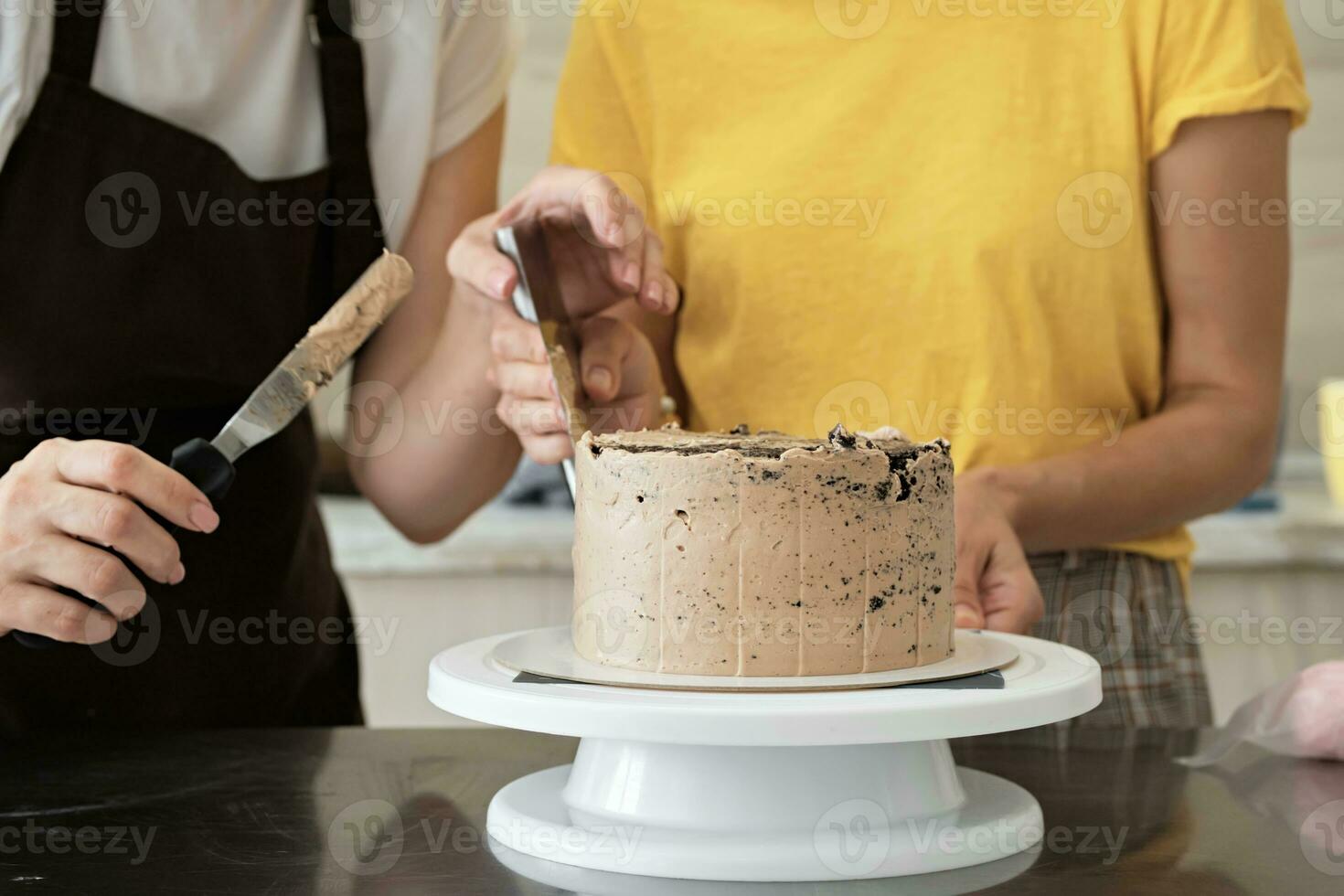 Women couple making chocolate cake in kitchen, close-up. Cake making process, Selective focus photo