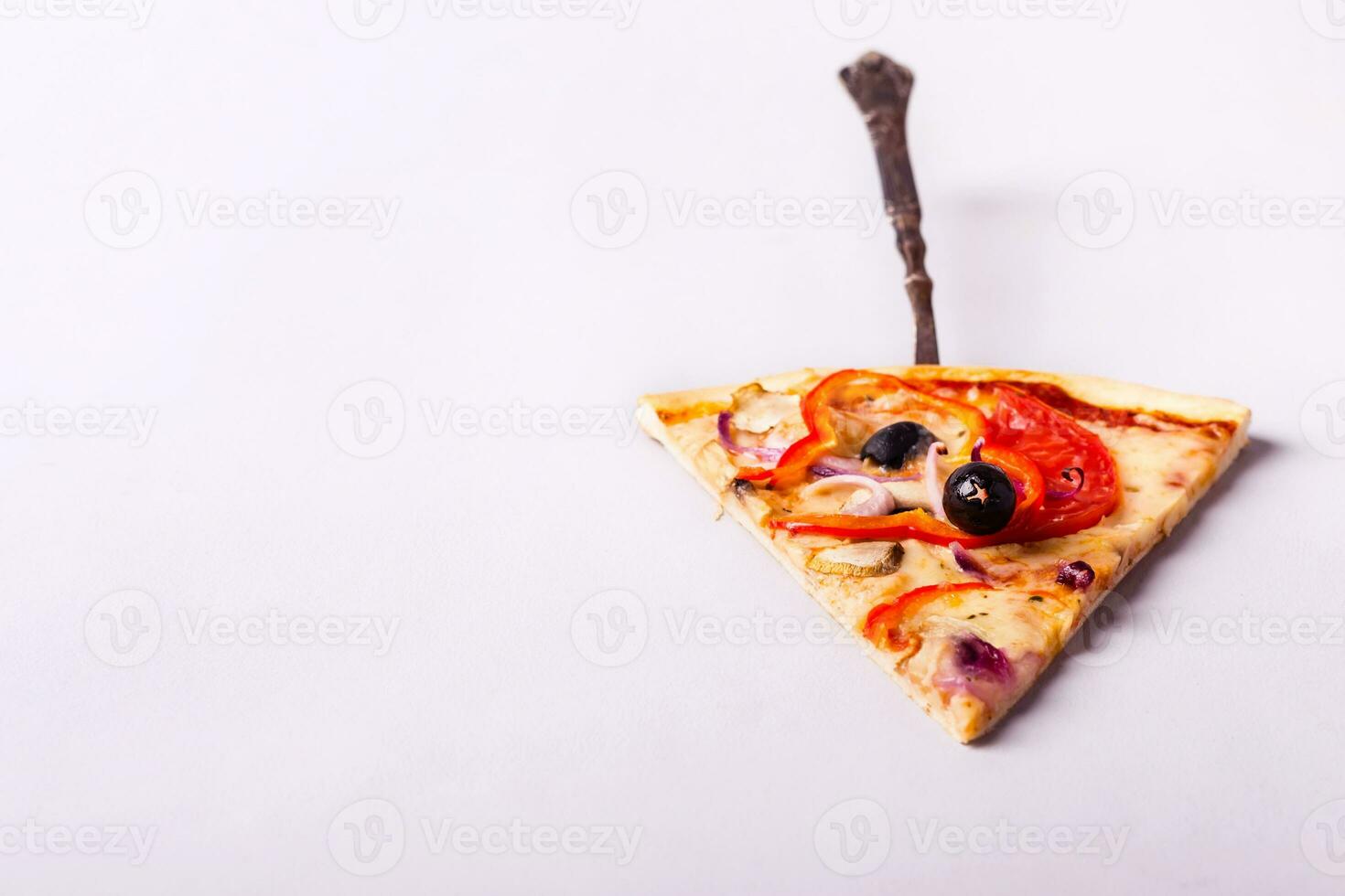 Piece of vegetarian pizza with mushrooms and olives on a white background photo