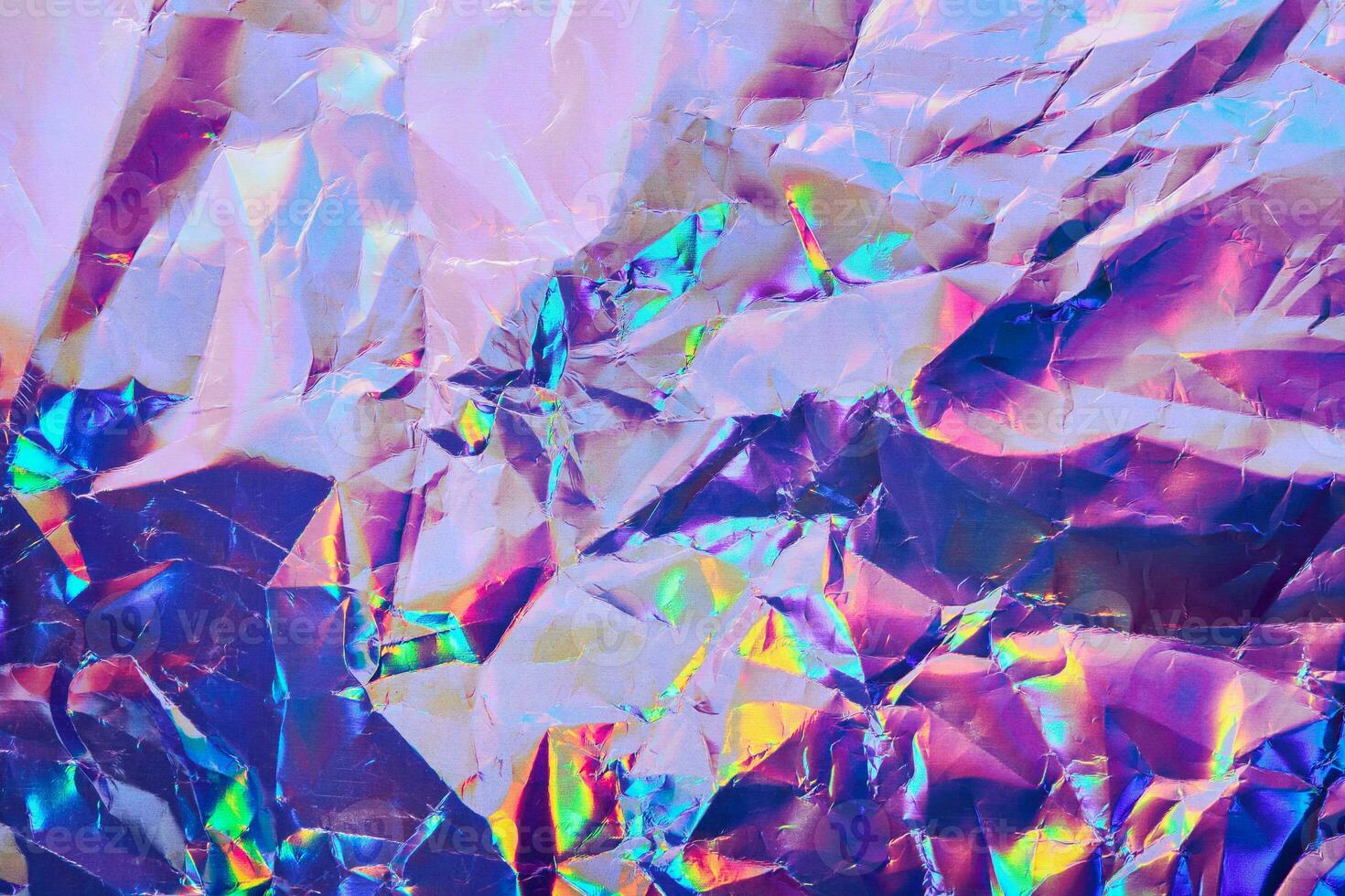 Iridescent holographic textural Background. Wrinkled folded paper or foil with iridescent highlights photo