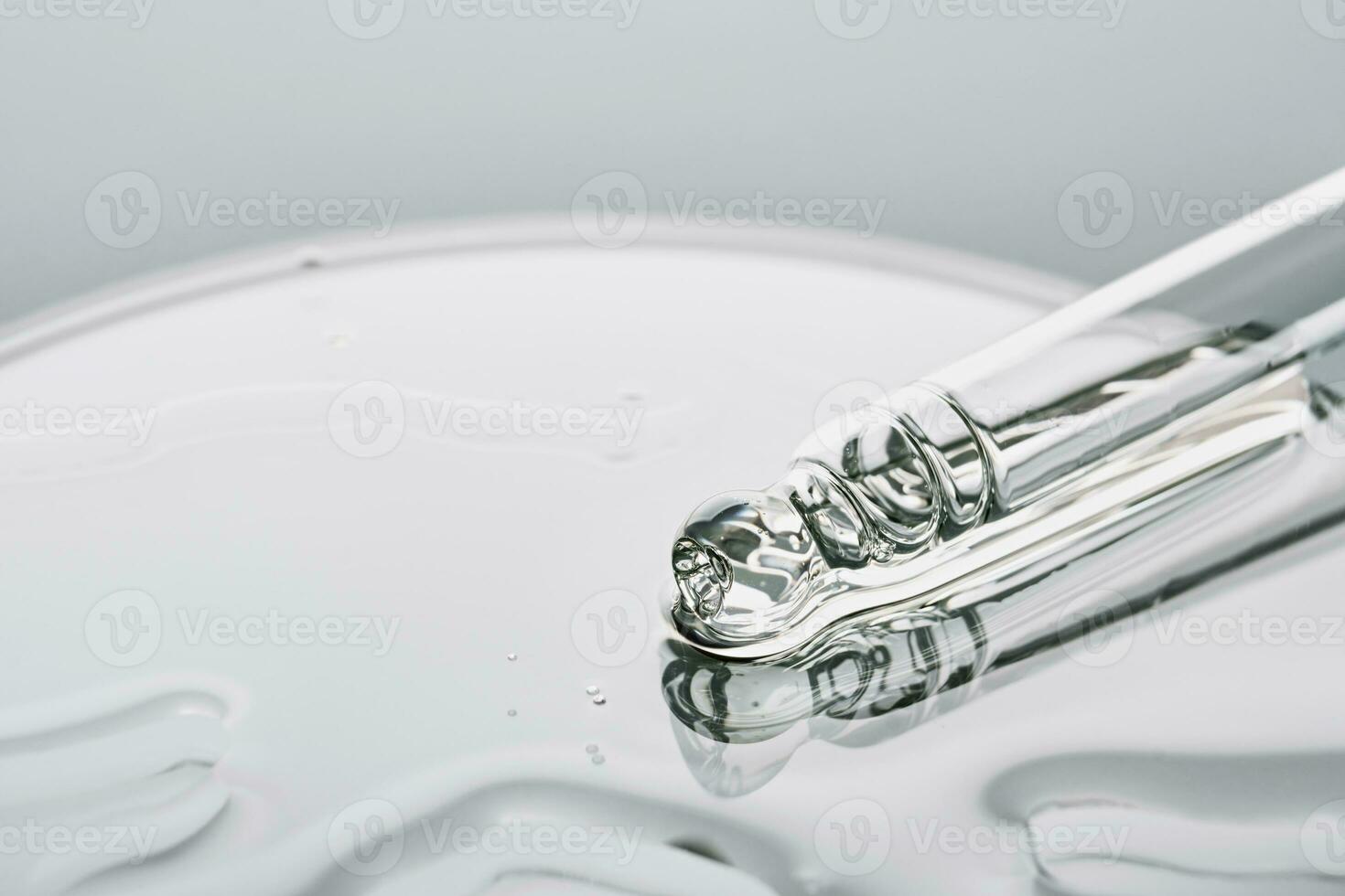 Pipette with sample of cosmetic product in petri dish on grey background, selective focus photo