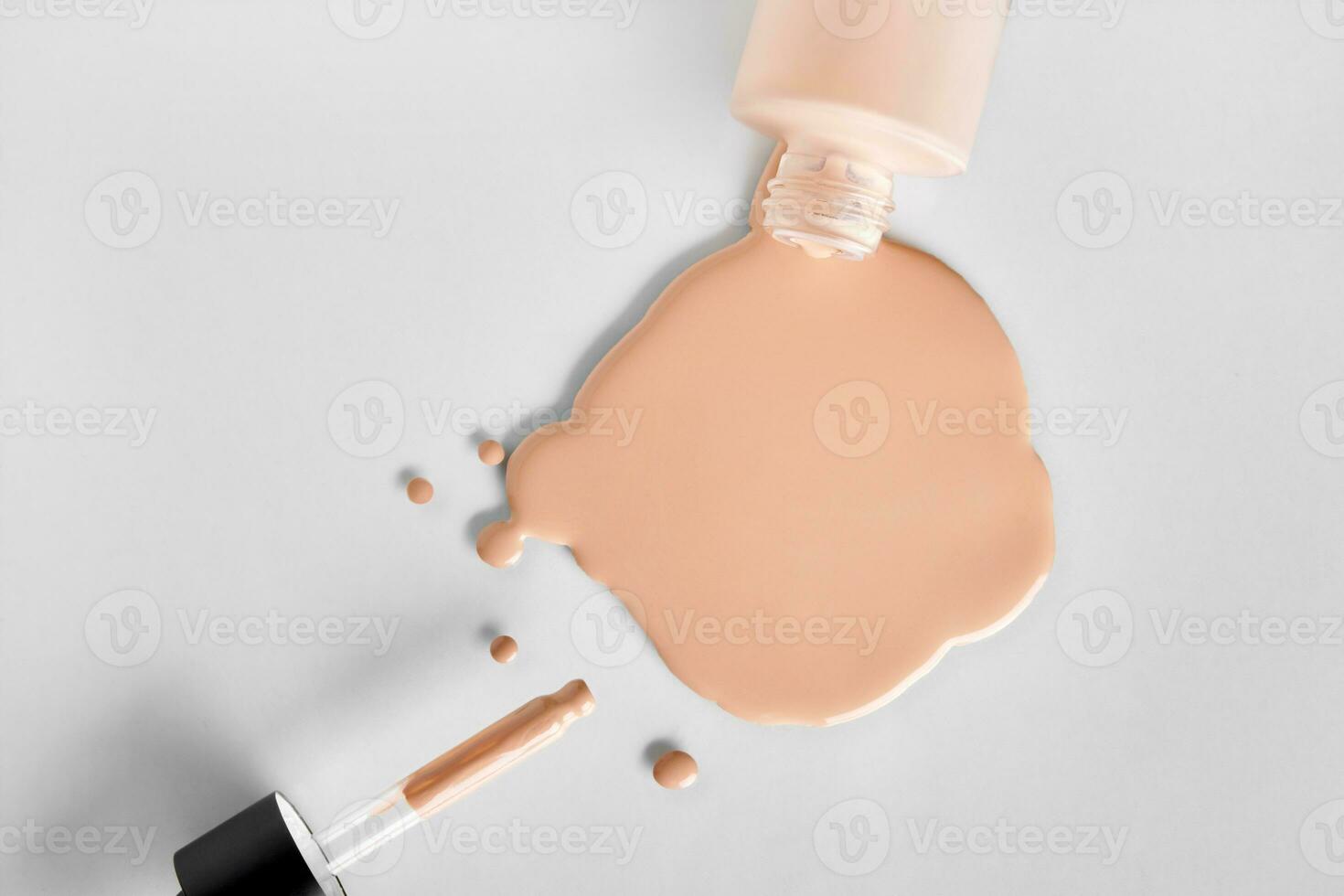 Mockup glass bottle of correction cosmetic product with pipette. Spilled Liquid foundation. Beauty branding concept photo