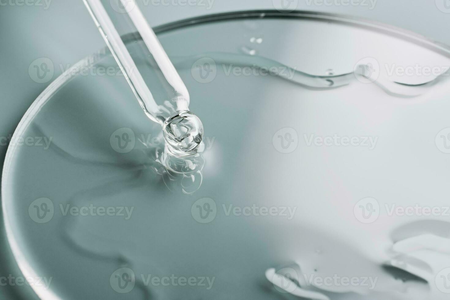 Pipette with sample of cosmetic product in petri dish on grey background, selective focus photo