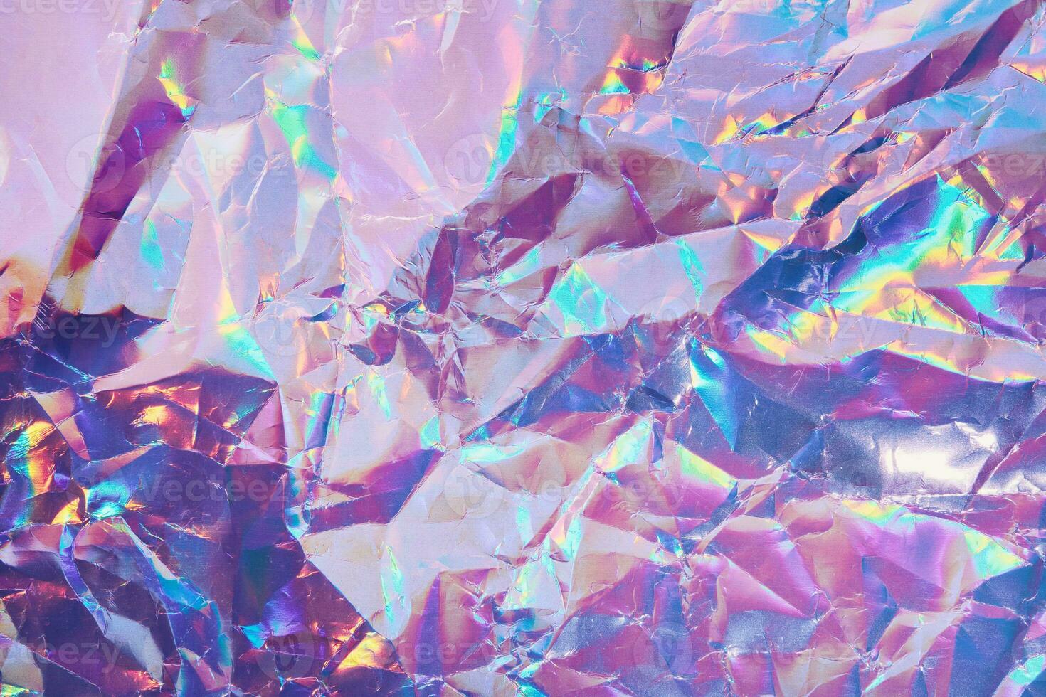 Iridescent holographic textural Background. Wrinkled folded paper or foil with iridescent highlights photo