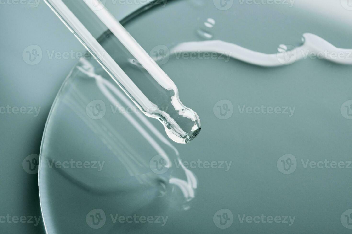 Pipette with sample of cosmetic product in petri dish on grey background, selective focus photo