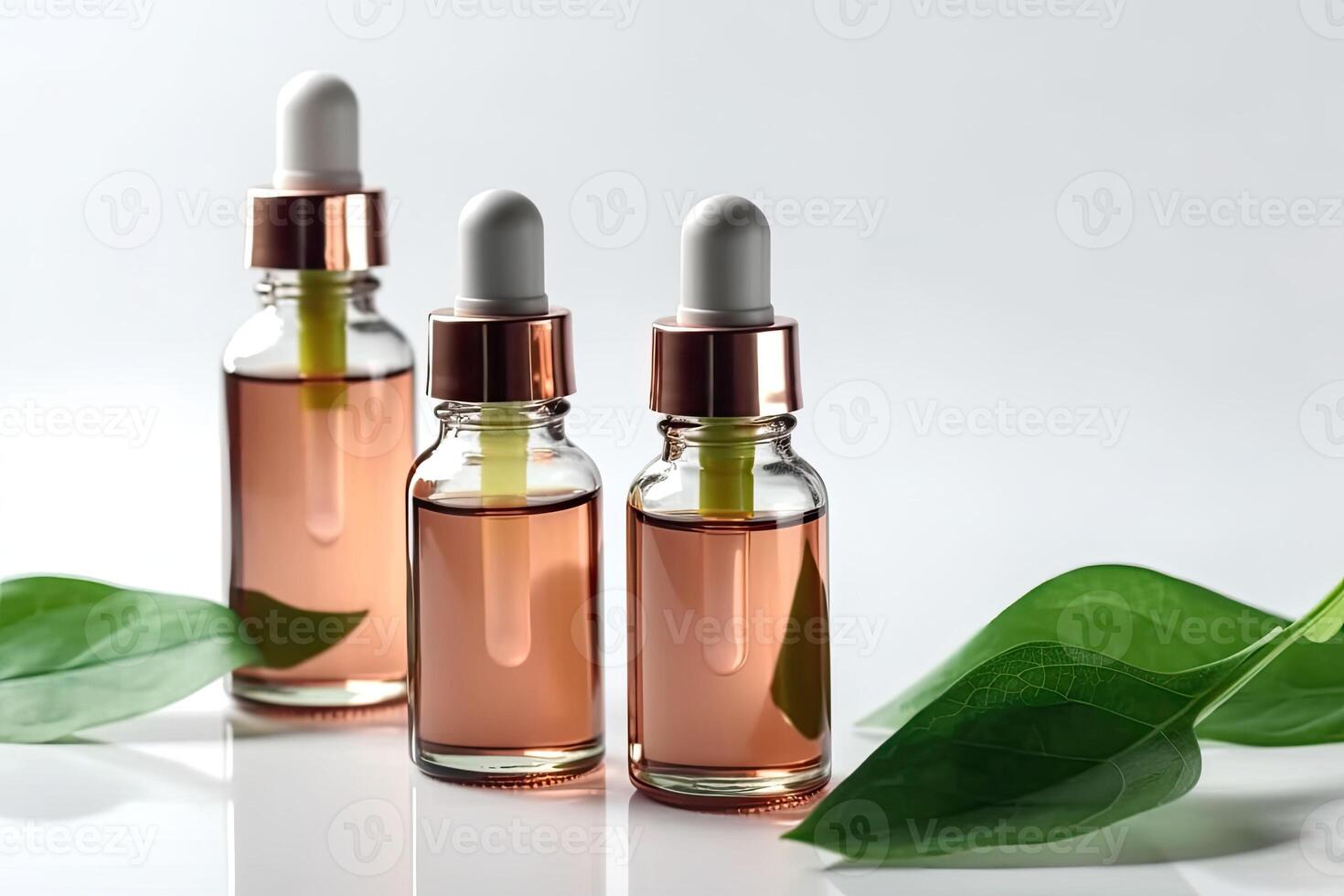 Cosmetic serum in a glass bottles with green leaves on light background. photo