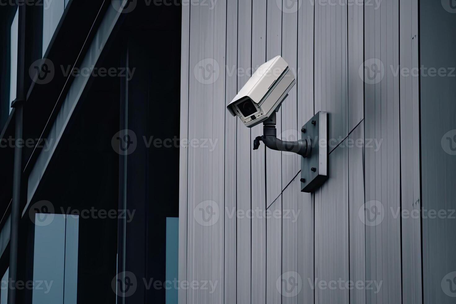 Security camera on modern building. CCTV on the wall in the city. photo