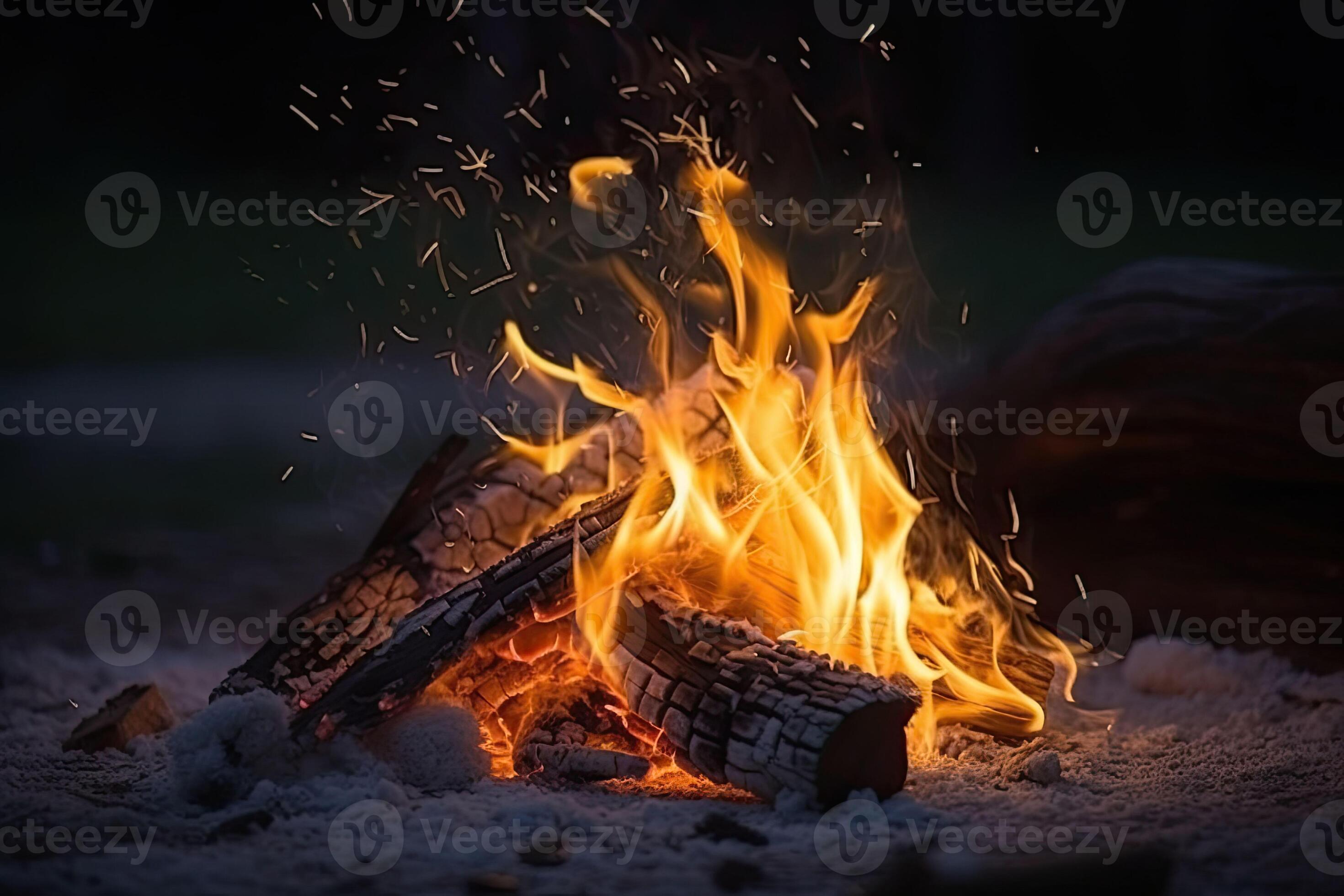 Campfire at touristic camp in the night. Flame and fire sparks on dark