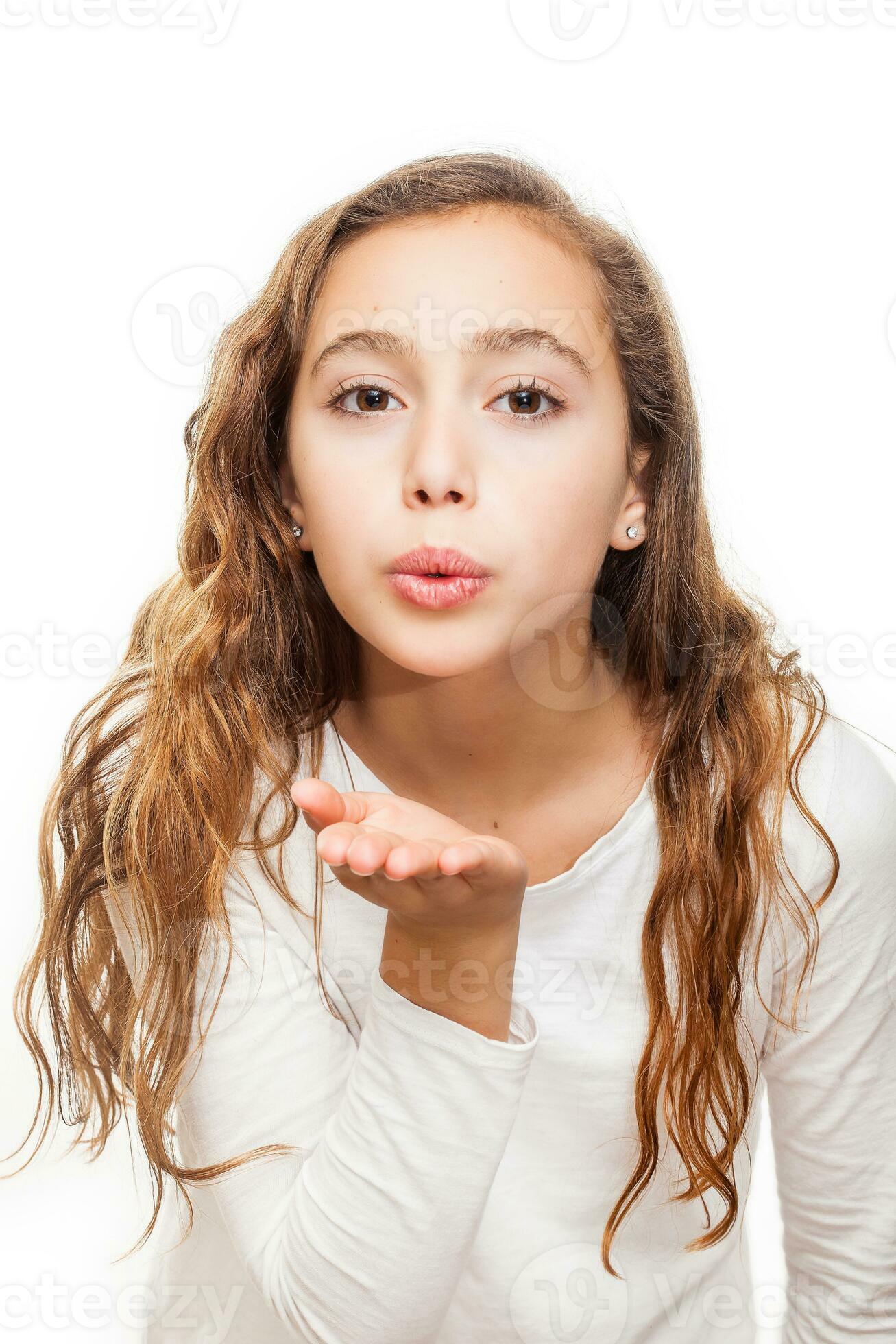Young girl blowing a kiss to the camera isolated on white background