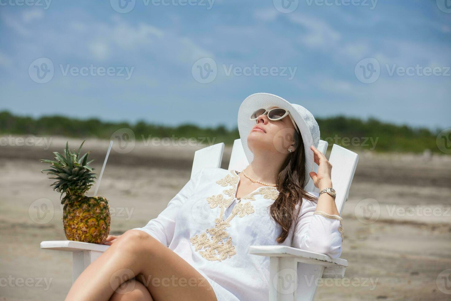 Woman relaxing at a paradisiac tropical beach in a beautiful sunny day photo