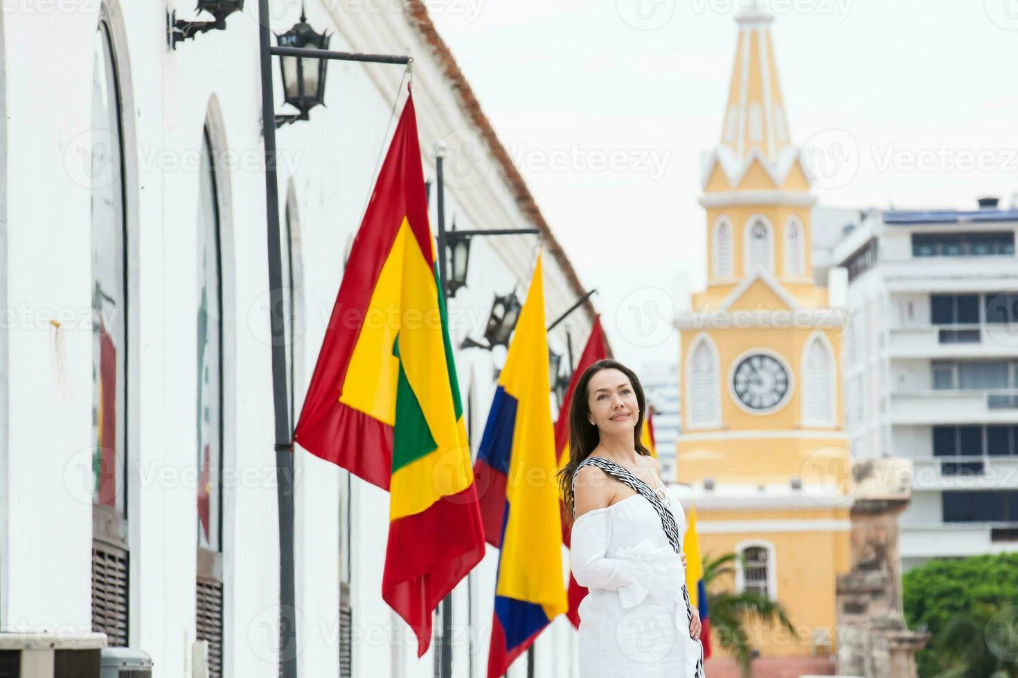 Beautiful woman walking around Cartagena de Indias next to the famous Clock Tower photo