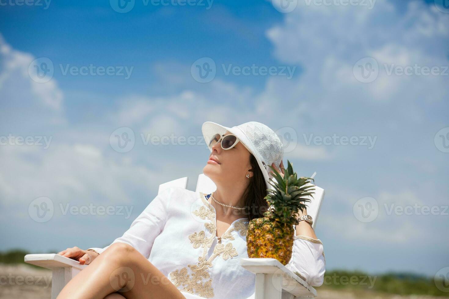 Woman relaxing at a paradisiac tropical beach in a beautiful sunny day photo