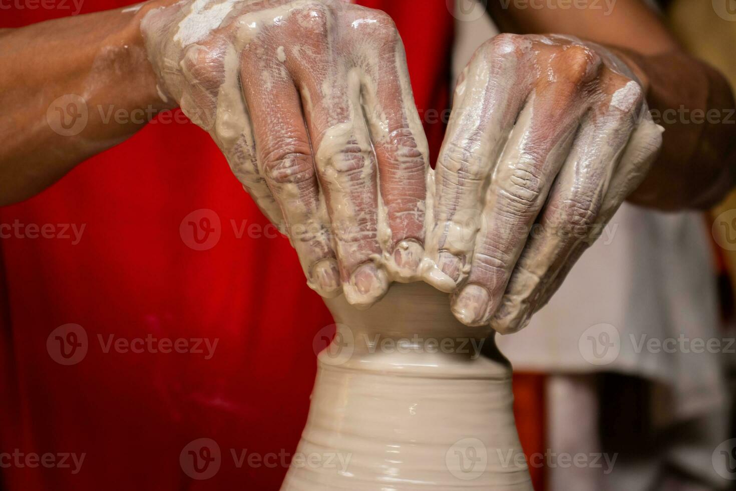Man making ceramic articles on the potters wheel in a traditional factory in the city of Raquira located in the department of Cundinamarca in Colombia photo