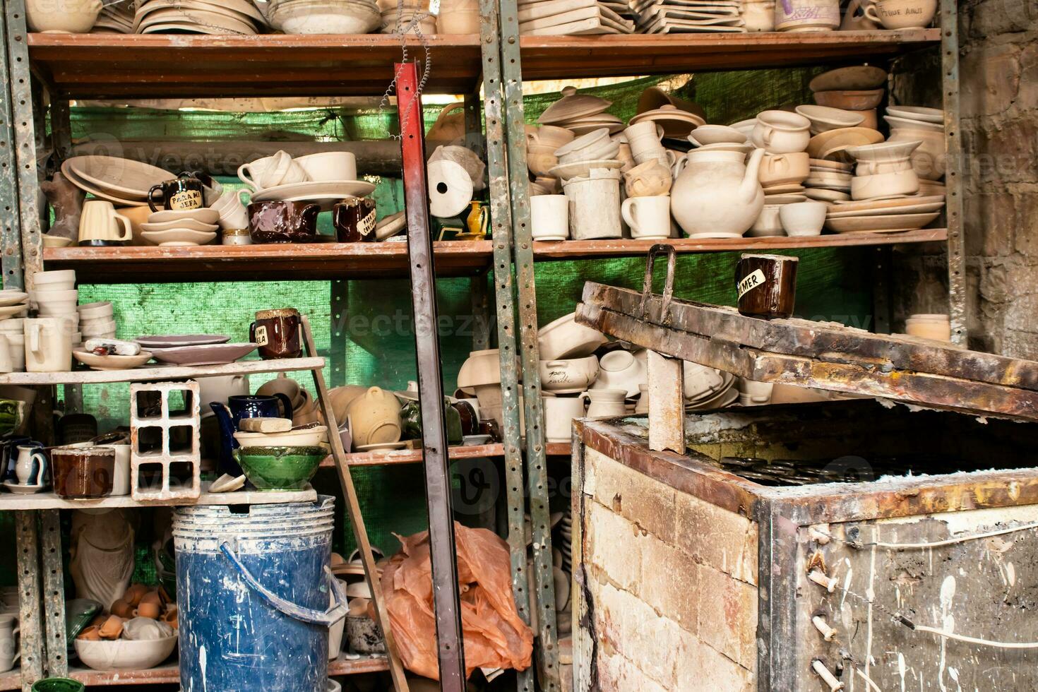 Ceramics on the elaboration process at a traditional factory at the small city of Raquira in Colombia photo