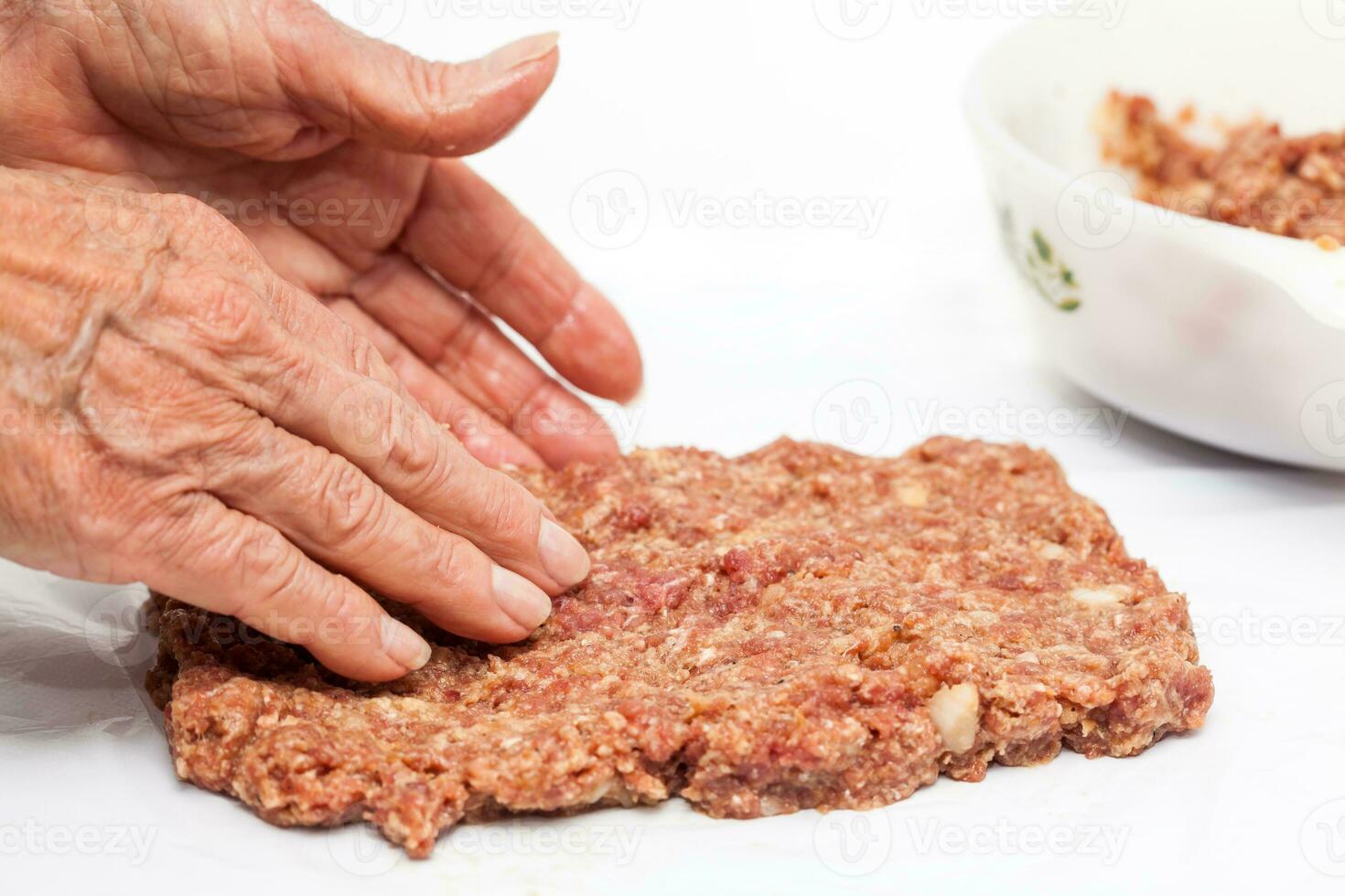 Preparation of a baked egg and vegetables stuffed meatloaf covered with bacon. Meat roll photo