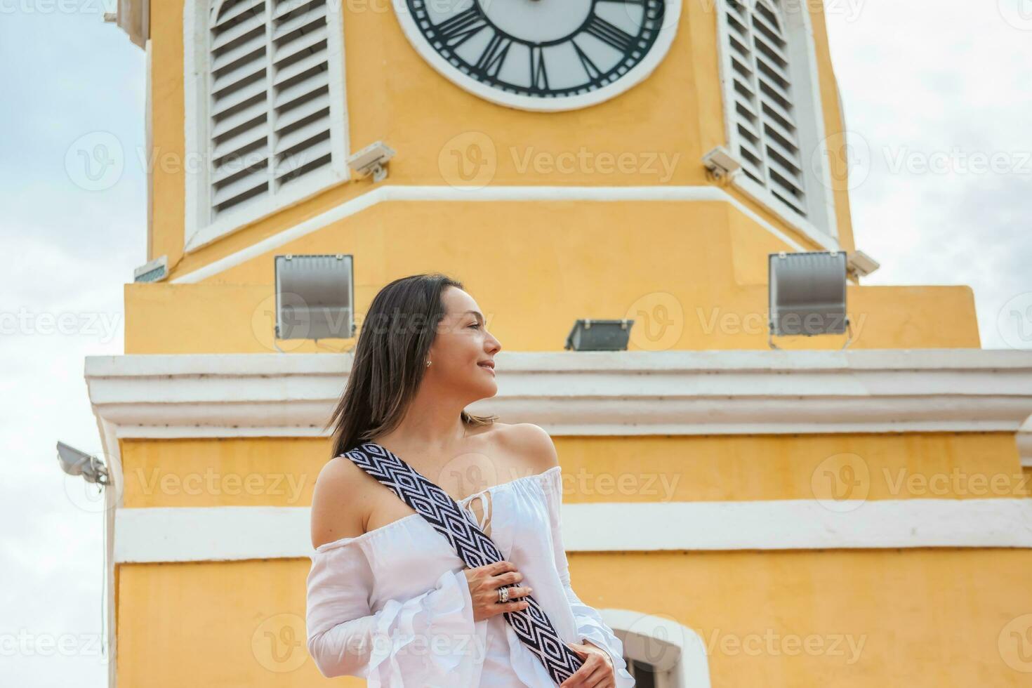 Beautiful woman walking around Cartagena de Indias next to the famous Clock Tower photo
