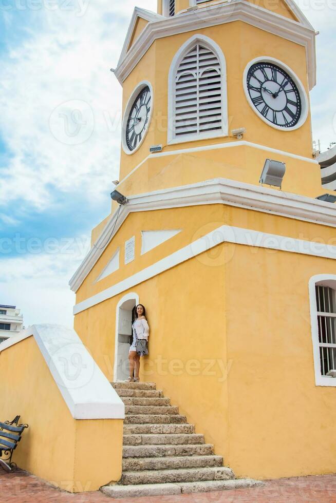Beautiful woman walking around Cartagena de Indias next to the famous Clock Tower photo